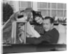 Husband wife man woman in automobile reading map by Anonymous