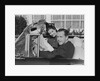 Husband wife man woman in automobile reading map by Anonymous