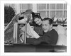 Husband wife man woman in automobile reading map by Anonymous