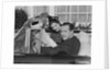 Husband wife man woman in automobile reading map by Anonymous