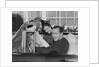 Husband wife man woman in automobile reading map by Anonymous