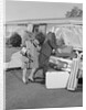 Senior man woman husband wife packing trunk with luggage by Anonymous