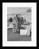 Senior man woman husband wife packing trunk with luggage by Anonymous