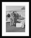 Senior man woman husband wife packing trunk with luggage by Anonymous