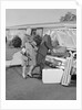 Senior man woman husband wife packing trunk with luggage by Anonymous