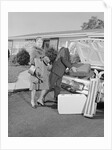 Senior man woman husband wife packing trunk with luggage by Anonymous