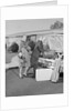 Senior man woman husband wife packing trunk with luggage by Anonymous