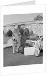 Senior man woman husband wife packing trunk with luggage by Anonymous