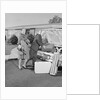 Senior man woman husband wife packing trunk with luggage by Anonymous