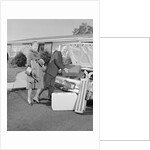 Senior man woman husband wife packing trunk with luggage by Anonymous