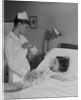 Woman nurse checking pulse taking temperature on little girl patient in hospital bed by Anonymous