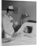 Woman nurse checking pulse taking temperature on little girl patient in hospital bed by Anonymous