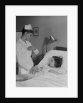 Woman nurse checking pulse taking temperature on little girl patient in hospital bed by Anonymous