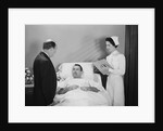 Man doctor woman nurse talking with male patient lying in hospital bed by Anonymous