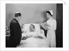 Man doctor woman nurse talking with male patient lying in hospital bed by Anonymous