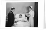 Man doctor woman nurse talking with male patient lying in hospital bed by Anonymous