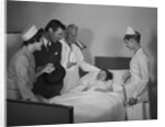 Man doctor woman nurse mother father seeing visiting smiling little girl patient in hospital bed by Anonymous
