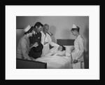 Man doctor woman nurse mother father seeing visiting smiling little girl patient in hospital bed by Anonymous