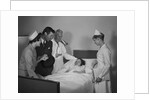 Man doctor woman nurse mother father seeing visiting smiling little girl patient in hospital bed by Anonymous