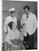 Man doctor woman nurse talking to smiling female patient sitting in hospital wheelchair by Anonymous