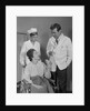 Man doctor woman nurse talking to smiling female patient sitting in hospital wheelchair by Anonymous