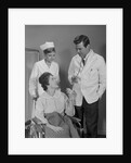 Man doctor woman nurse talking to smiling female patient sitting in hospital wheelchair by Anonymous