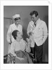 Man doctor woman nurse talking to smiling female patient sitting in hospital wheelchair by Anonymous