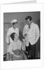 Man doctor woman nurse talking to smiling female patient sitting in hospital wheelchair by Anonymous