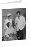 Man doctor woman nurse talking to smiling female patient sitting in hospital wheelchair by Anonymous