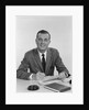 Smiling happy businessman pen in hand signing papers at desk by Anonymous