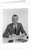Smiling happy businessman pen in hand signing papers at desk by Anonymous