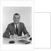 Smiling happy businessman pen in hand signing papers at desk by Anonymous