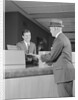 Businessman making a deposit into savings account with bank teller by Anonymous