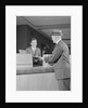 Businessman making a deposit into savings account with bank teller by Anonymous