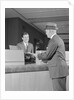 Businessman making a deposit into savings account with bank teller by Anonymous