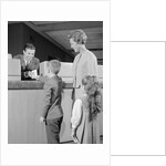 Mother two children boy handing banking deposit to male bank teller by Anonymous