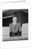 Smiling man bank teller savings accounts sign on counter by Anonymous