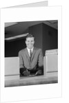 Smiling man bank teller savings accounts sign on counter by Anonymous