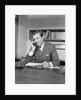 Businessman executive at desk talking on telephone by Anonymous