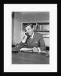 Businessman executive at desk talking on telephone by Anonymous