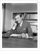 Businessman executive at desk talking on telephone by Anonymous