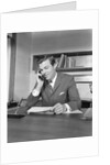 Businessman executive at desk talking on telephone by Anonymous