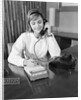 Secretary receptionist talking on telephone writing into desk calendar by Anonymous