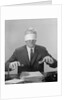 Business man hands hovering over desk wearing blindfold by Anonymous