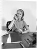 Blond businesswoman talking on telephone sitting at desk by Anonymous
