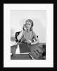 Blond businesswoman talking on telephone sitting at desk by Anonymous