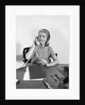 Blond businesswoman talking on telephone sitting at desk by Anonymous