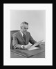 Businessman executive middle aged sitting at desk reading papers by Anonymous