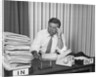 Concerned businessman staring large pile paperwork in in-box by Anonymous