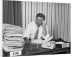 Concerned businessman staring large pile paperwork in in-box by Anonymous